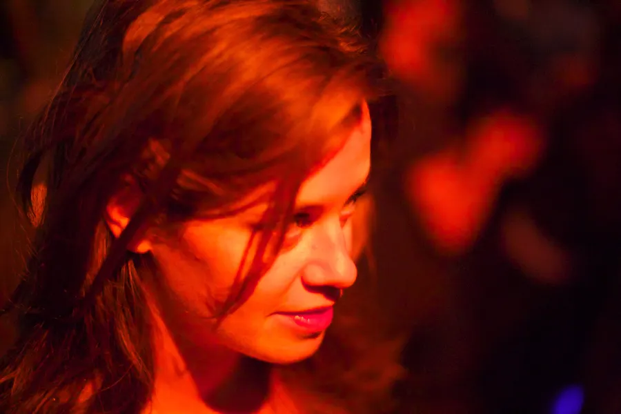 A woman's face in warm red light